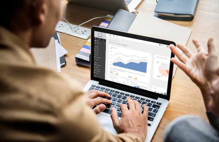 Colleagues reviewing a business analytics dashboard on a laptop during a working session